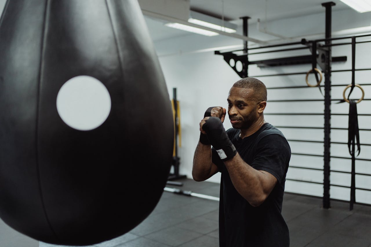 Man Standing Near the Speed Bag